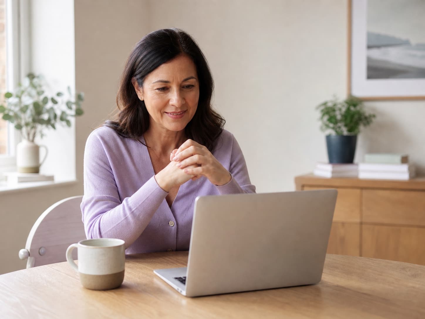 A midlife woman meeting virtually with a menopause clinician from home